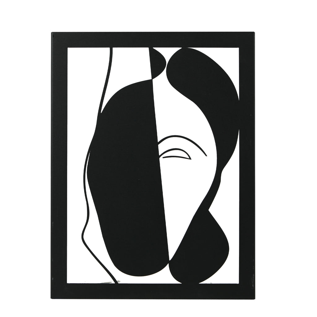 Minimalist abstract face wall art in black metal hanging on white wall
