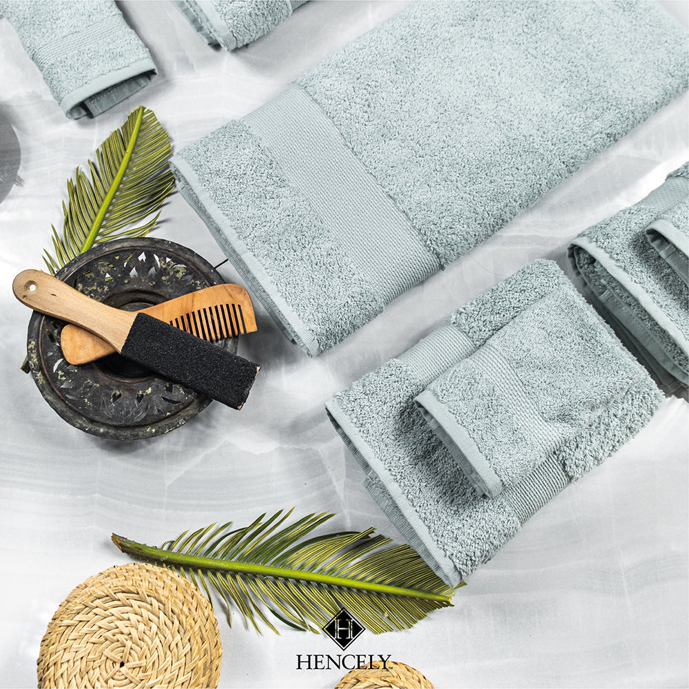 Light green Turkish cotton bath sheets displayed in a spa-inspired setting with palm leaves, wooden accessories, and natural decor for a luxurious look.