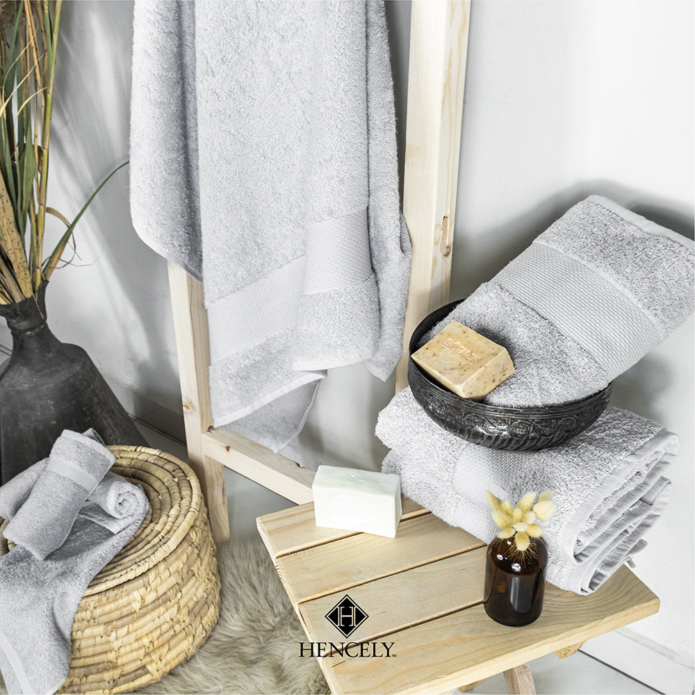 Silver cotton bath sheet set displayed in a spa-inspired bathroom with natural soap, basket, and decor for a luxury look.