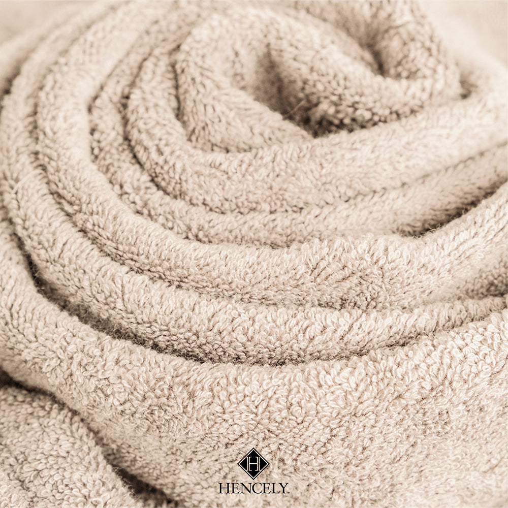 Close-up view of a beige Turkish cotton bath sheet highlighting its soft and fluffy texture, neatly rolled with visible loops.