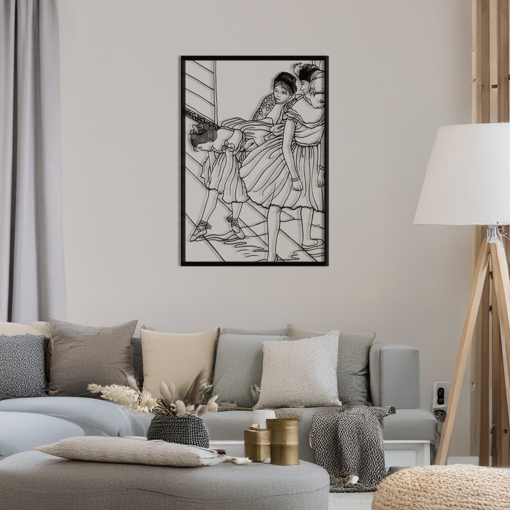 Black metal wall art of Edgar Degas’ ballerinas displayed in a modern living room.