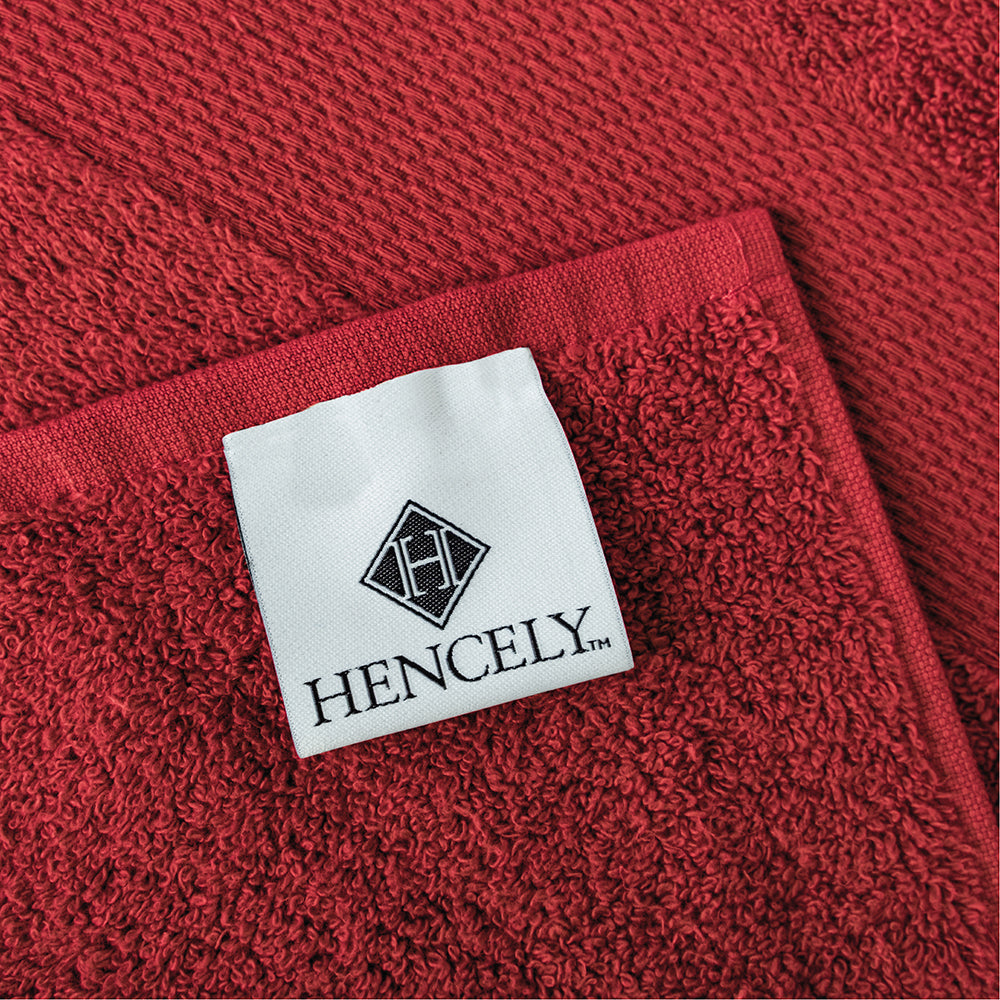 Close-up of Hencely burgundy bath sheet with stitched brand label and soft cotton texture