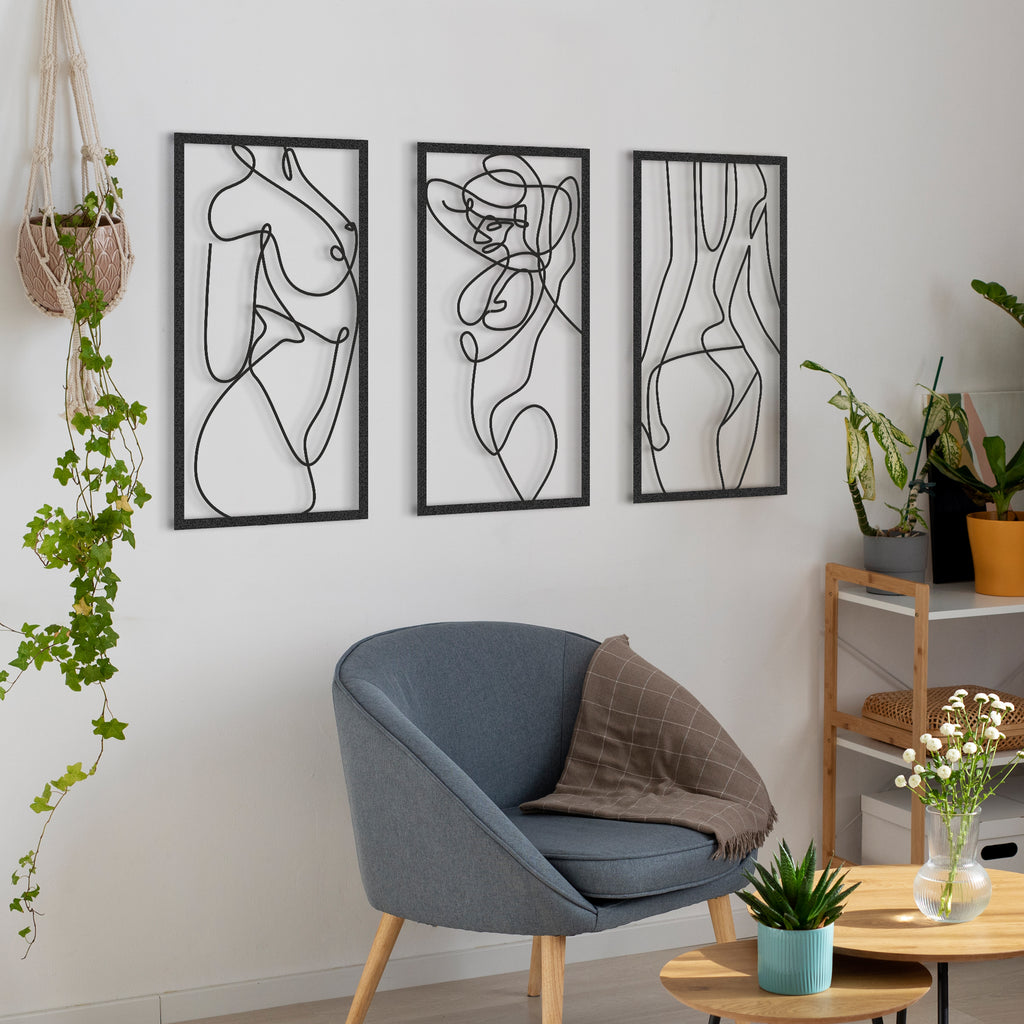 Living room with 3-panel Nude Woman Black Metal Wall Art above chair and plants