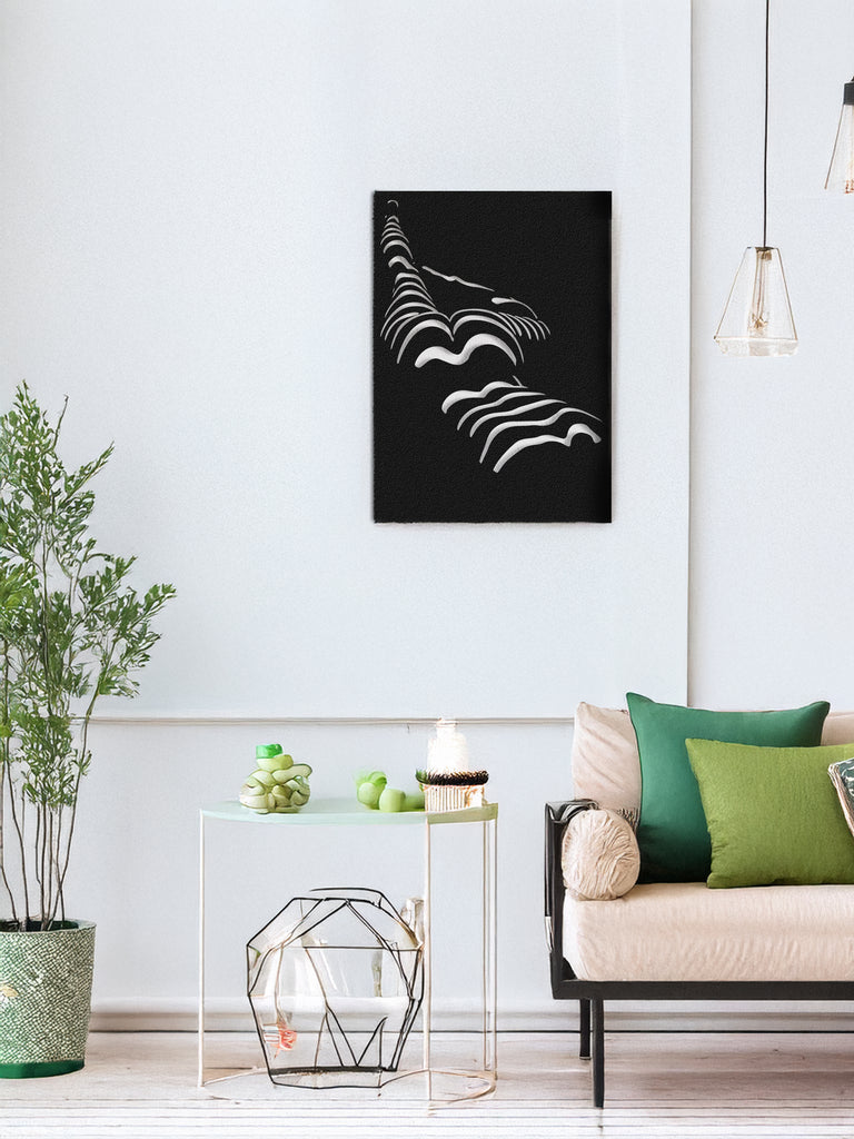 Woman in Dark black metal wall art displayed above sofa in modern living room